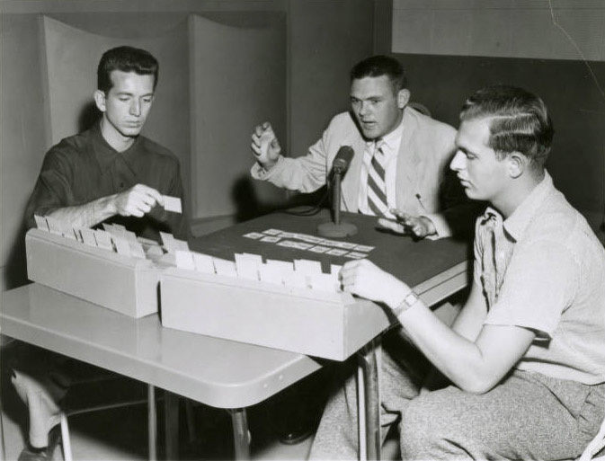 1953—Keith Jackson (center) demonstrates how KWSC recreated a WSC game at Baylor for local radio broadcast